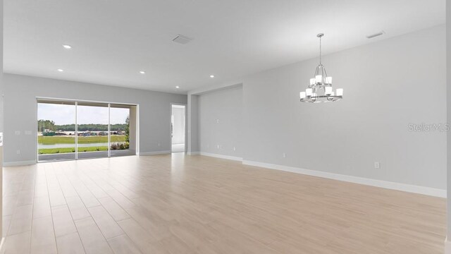 5646 Nevis Ter, Kissimmee, FL 34758 - spare room with a chandelier, light wood-style flooring, baseboards, and recessed lighting