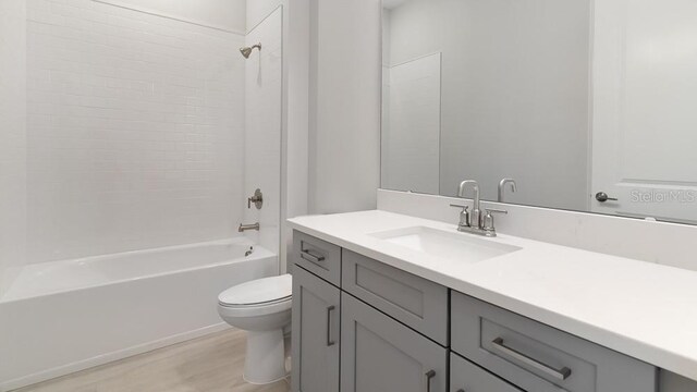 5646 Nevis Ter, Kissimmee, FL 34758 - bathroom with toilet, wood finished floors, tub / shower combination, and vanity