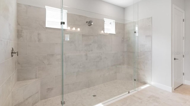5646 Nevis Ter, Kissimmee, FL 34758 - full bathroom with a stall shower, tile patterned flooring, and baseboards