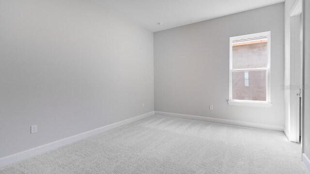 5646 Nevis Ter, Kissimmee, FL 34758 - spare room featuring light carpet and baseboards