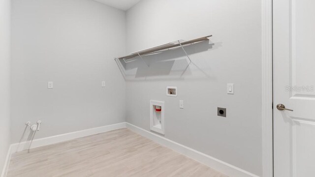5646 Nevis Ter, Kissimmee, FL 34758 - laundry room with light wood-type flooring, baseboards, hookup for a washing machine, and hookup for an electric dryer