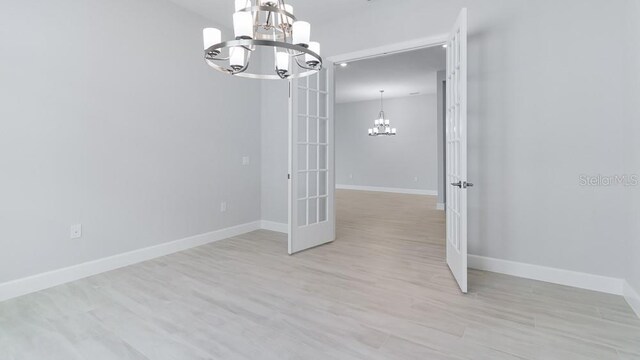 5646 Nevis Ter, Kissimmee, FL 34758 - empty room with a chandelier, french doors, and baseboards
