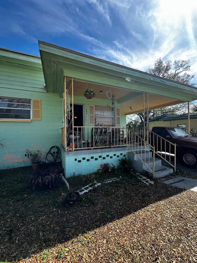 exterior space with a porch and an attached carport