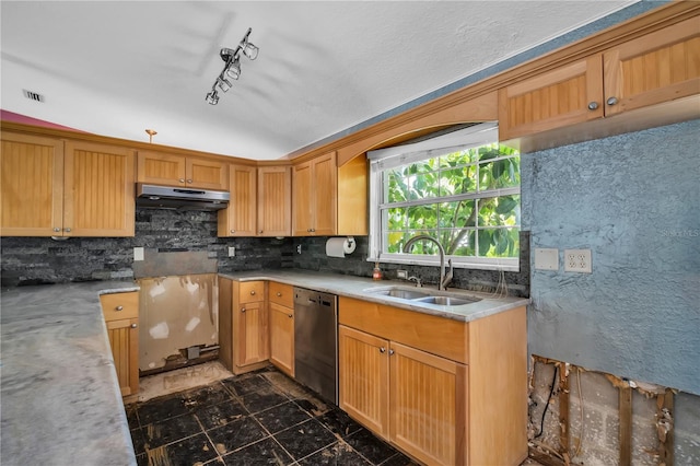 kitchen featuring decorative backsplash, dishwasher, light countertops, under cabinet range hood, and a sink