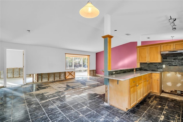 kitchen with lofted ceiling, under cabinet range hood, visible vents, light countertops, and tasteful backsplash