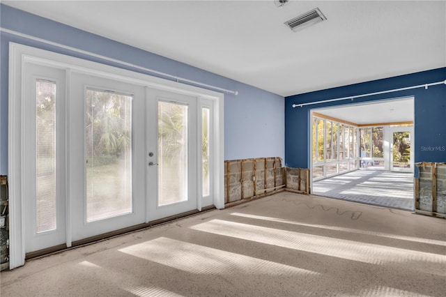 doorway to outside featuring a wealth of natural light, french doors, and visible vents