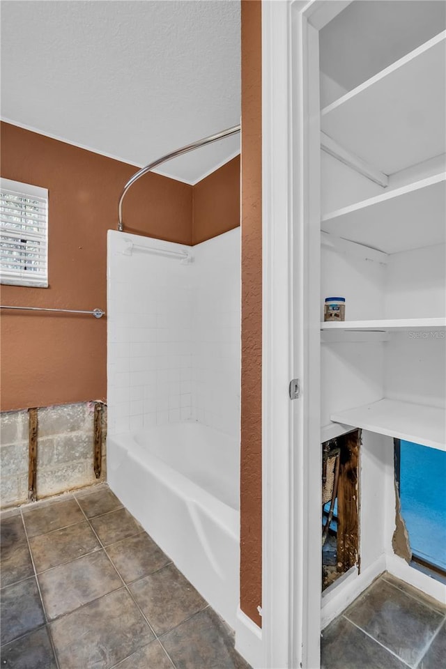 bathroom with shower / tub combination, a textured ceiling, and tile patterned floors