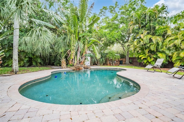 view of swimming pool featuring a fenced in pool, a fenced backyard, and a patio area