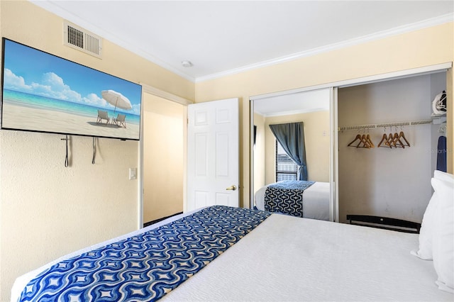 bedroom featuring a closet, visible vents, and crown molding