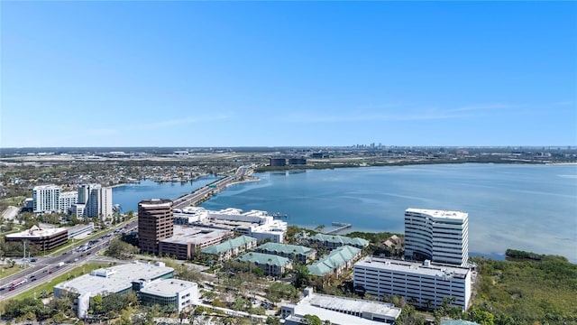 birds eye view of property with a water view and a city view