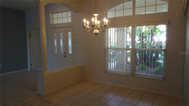 interior space with arched walkways, a notable chandelier, and baseboards