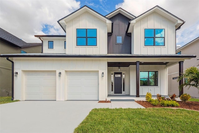 modern farmhouse style home with concrete driveway, an attached garage, a standing seam roof, covered porch, and board and batten siding