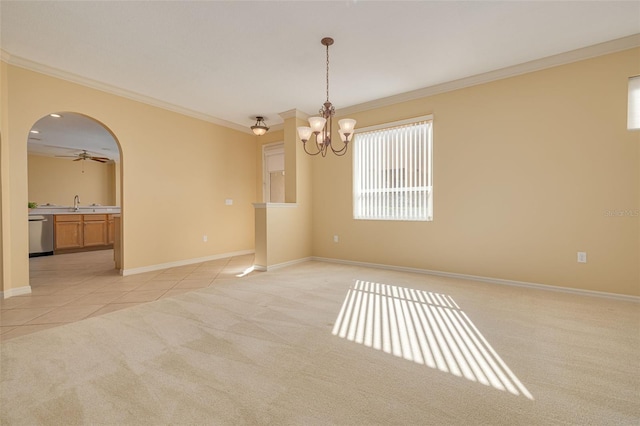 spare room with light carpet, light tile patterned floors, baseboards, arched walkways, and crown molding