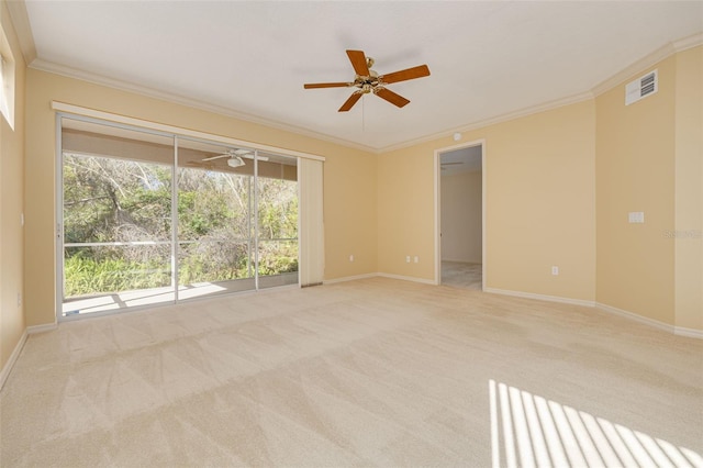 carpeted empty room with ornamental molding, visible vents, ceiling fan, and baseboards