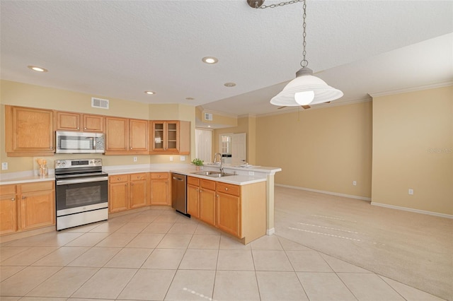 kitchen with visible vents, light colored carpet, appliances with stainless steel finishes, a peninsula, and a sink