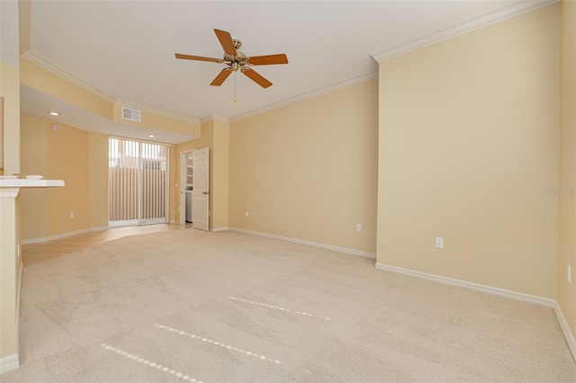 empty room featuring carpet floors, visible vents, ornamental molding, and baseboards