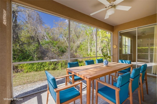 sunroom featuring a ceiling fan