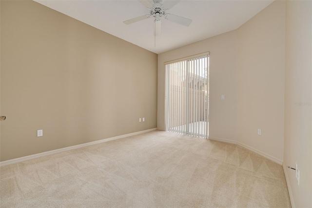 spare room featuring light carpet, ceiling fan, and baseboards