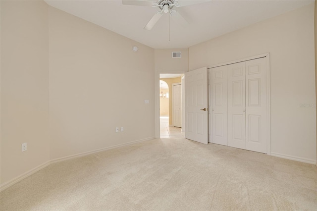 unfurnished bedroom featuring light carpet, baseboards, visible vents, a ceiling fan, and a closet