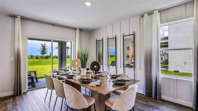 dining space with baseboards and wood finished floors