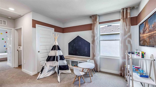 recreation room with carpet floors, visible vents, and baseboards