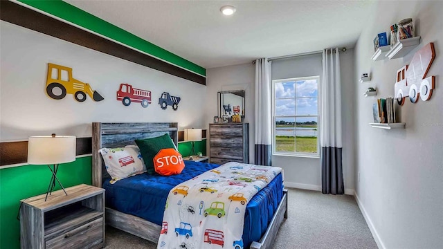 carpeted bedroom featuring baseboards