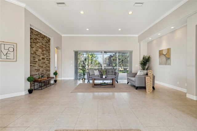 living area with arched walkways, visible vents, and crown molding