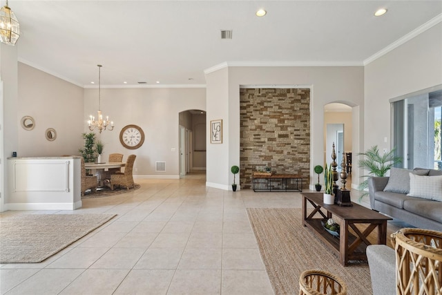 living area featuring light tile patterned floors, visible vents, arched walkways, and crown molding