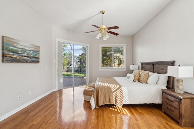 bedroom featuring ceiling fan, vaulted ceiling, wood finished floors, access to outside, and baseboards