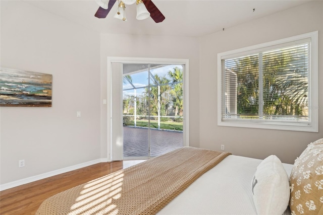 bedroom with access to outside, ceiling fan, baseboards, and wood finished floors