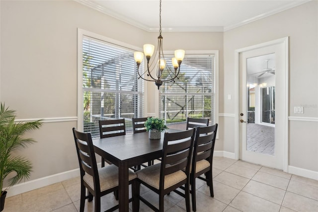 dining space featuring light tile patterned floors, baseboards, ornamental molding, and a chandelier