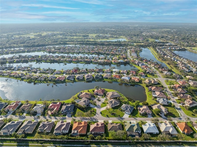 birds eye view of property featuring a water view and a residential view