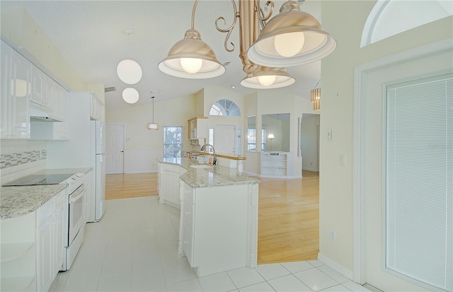 kitchen featuring white cabinetry, white appliances, light tile patterned floors, and a sink