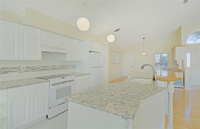 kitchen featuring under cabinet range hood, a sink, white appliances, white cabinets, and vaulted ceiling