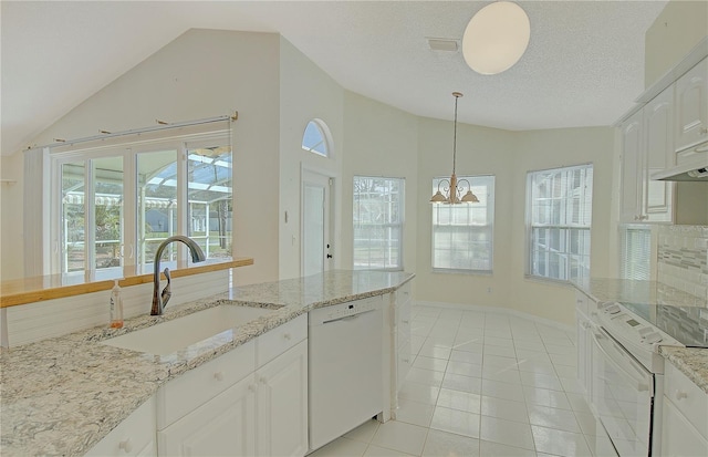 kitchen featuring lofted ceiling, light tile patterned floors, white cabinets, white appliances, and a sink