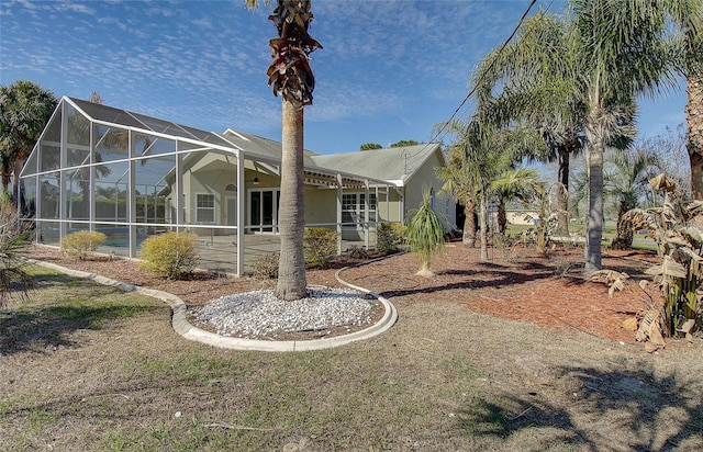 exterior space featuring a lanai, a patio area, and stucco siding