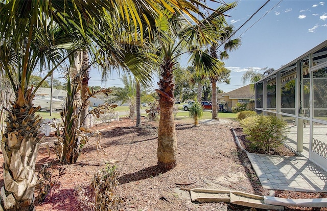view of yard with glass enclosure
