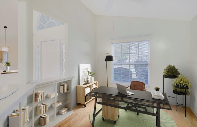office area with light wood-type flooring and vaulted ceiling