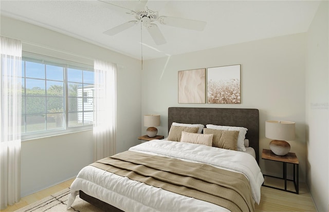 bedroom featuring light wood-type flooring and a ceiling fan