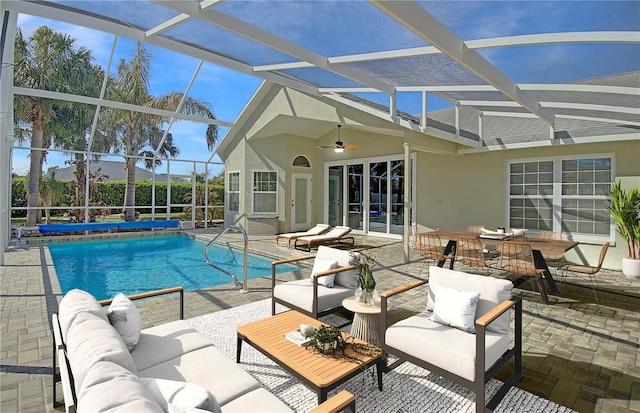 view of pool featuring outdoor lounge area, a patio, and a lanai
