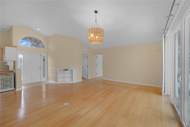 10302 Belltower St, Spring Hill, FL 34608 - foyer featuring a chandelier, light wood-style floors, baseboards, and high vaulted ceiling