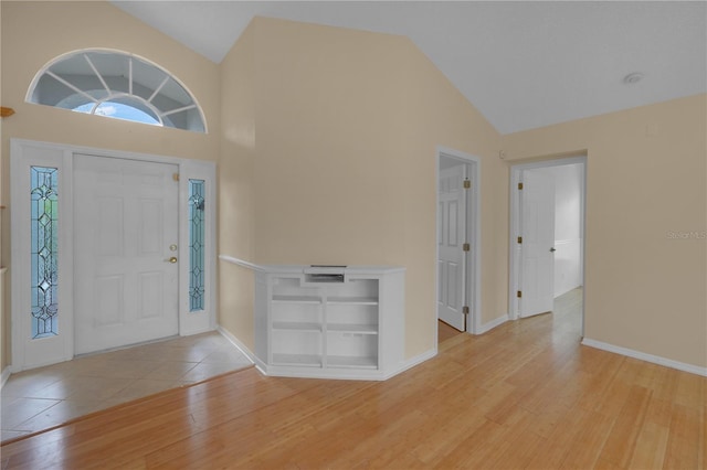 10302 Belltower St, Spring Hill, FL 34608 - foyer with light wood-type flooring, high vaulted ceiling, and baseboards