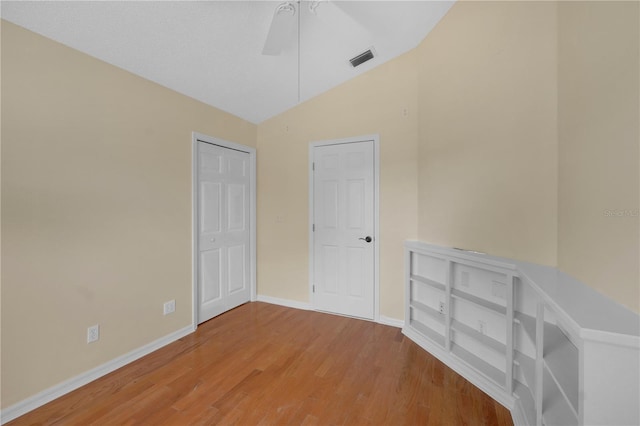 10302 Belltower St, Spring Hill, FL 34608 - spare room featuring vaulted ceiling, baseboards, wood finished floors, and a ceiling fan