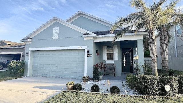 ranch-style house featuring a garage, driveway, and stucco siding