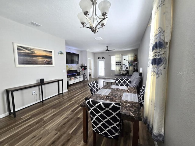 living room with dark wood finished floors, ceiling fan with notable chandelier, baseboards, and visible vents