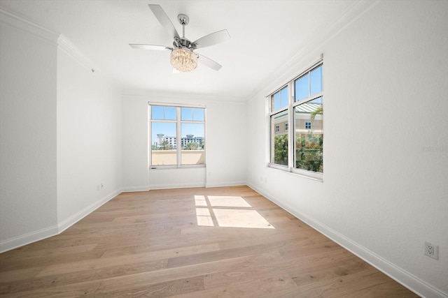 unfurnished room featuring baseboards, ceiling fan, light wood-type flooring, and crown molding