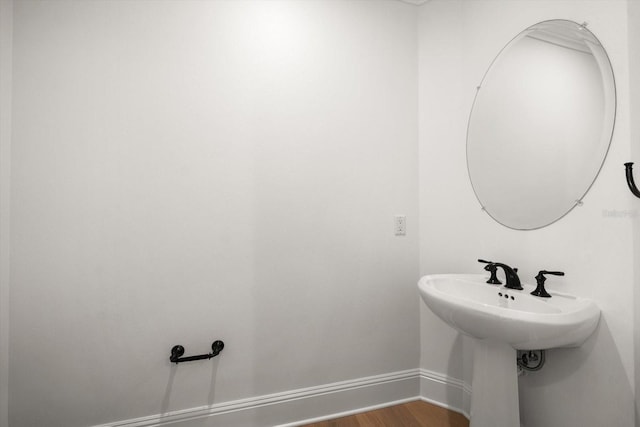 bathroom featuring wood finished floors and baseboards