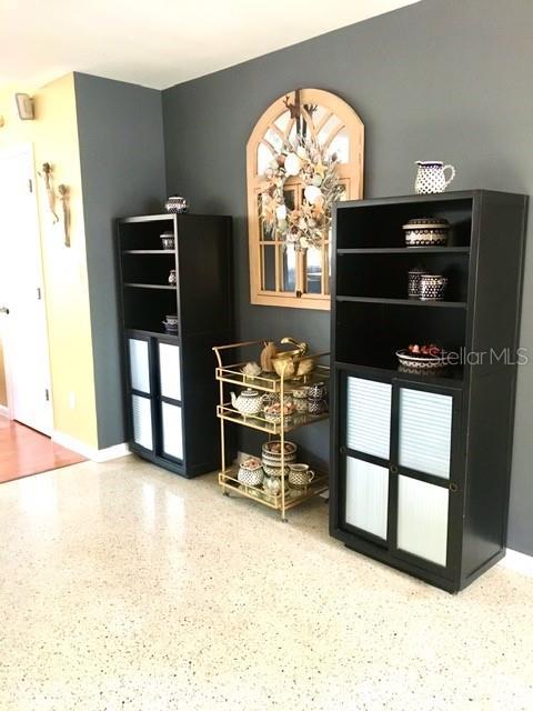 bar featuring baseboards and speckled floor