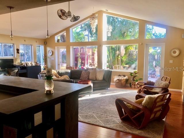 sunroom / solarium with ceiling fan and vaulted ceiling