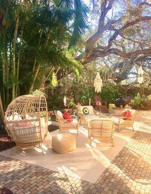 view of patio featuring an outdoor hangout area and fence